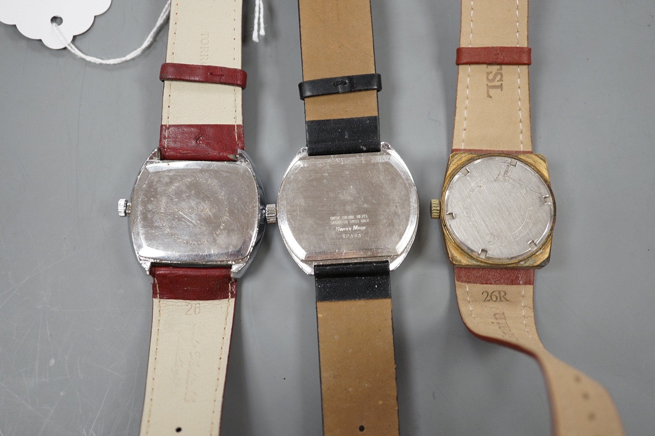 Three assorted steel or gilt steel jump hour digital manual wind wrist watches, including Astral and Lanco.